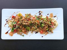 a white plate topped with food on top of a wooden table