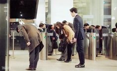 several people are waiting in line at an airport