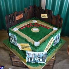 a baseball field shaped cake with photos on the top and bottom tier, in front of a green curtain