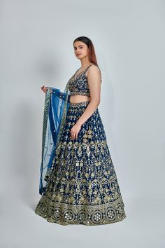 ABOUT Blue lehenga with all-over zari, dabka & nakshi work. Paired with a padded embroidered blouse and mirror work border dupatta. No of Components: 3 Components: Blouse, Dupatta, Lehenga Pattern: Embroidered Type of Work: Dabka, Nakshi, Zari Neckline: Sweetheart Sleeve Type: Sleeveless Fabric: Georgette Color: Blue Embroidered dupatta Please note: Originally stitched in size 36 but can be altered for size 34 without any extra cost. Designer Fitted Meenakari Choli, Designer Anarkali Choli With Meenakari, Anarkali Choli With Meenakari For Designer Wear, Blue Meenakari Anarkali Set For Diwali, Semi-stitched Blue Anarkali Set With Meenakari, Blue Semi-stitched Anarkali Set With Meenakari, Blue Meenakari Anarkali Set For Eid, Festive Blue Anarkali Set With Meenakari, Fitted Bollywood Lehenga With Meenakari