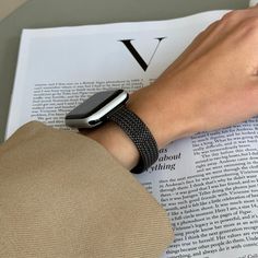 a person reading a book with an apple watch on their wrist