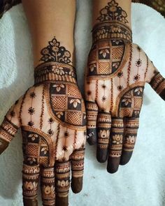 two hands with henna designs on them