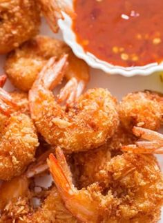 fried shrimp and dipping sauce on a white plate