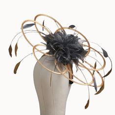 This is a looped fascinator hat with a central adornment of feathers which are set in smaller loops in the same colour satin as the feathers.  this version of this style also has a set of long feathers in the same colour as the satins so in the example of the photo we have long feathers in gold and shorter feathers in pewter to match the pewter satin loops in the centre. If you need more feathers i can add for an extra cost.  To choose a different colour combo just choose from the drop-down boxes. This item will be set on a 2cm wide headband which will be covered in the same satin as your base loops.  As you can see in the photos i also add an elastic millinery band that fits at the back of the neck and under the hair, for extra security.  I cannot place on a comb or covered headband. This Wide Brim Feathered Fascinator, Royal Ascot Wide Brim Fascinator With Feather Trim, Elegant Gold Fascinator With Feathers, Royal Ascot Feather Trim Hat, Luxury Feather Trim Hat Fascinator, Fascinator Hats Wedding, Feather Fascinators, Wide Headband, Red Satin