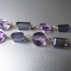 "Small faceted discs of lilac amethyst are paired with faceted tubes of smoky-blue iolite, linked with 14k gold wire into a 22\" chain. The large (20mm), smooth amethyst marble pendant is removable --it clips onto the necklace with the handmade hook clasp. *The modeled necklace is a similar necklace that has sold. Check out Jenco Studios at: www.jencostudio.com and www.facebook.com/jencostudios for work in sterling silver, new work previews, info on upcoming sales and signing up for the Jenco St Lilac Amethyst, Smoky Blue, 14k Gold Necklace, Hook Clasp, Gold Wire, Quartz Necklace, Rose Gold Necklace, Gorgeous Necklaces, Moon Stone