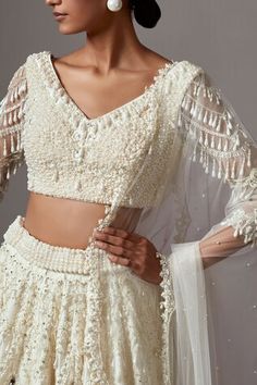 Ivory lehenga featuring embroidered floral motifs in scalloped patterns, highlighted by pearls ,crystals and sequins. Comes with matching blouse highlighted by pearl and crystal cluster patterns. Paired with embellished dupatta. - Aza Fashions Ivory Lehenga, Heavy Necklace, Latest Bridal Lehenga, Embroidered Lehenga, Bridal Lehengas, Beaded Blouse, Western Wedding, Ivory Pearl, Wedding Service