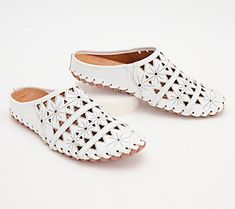 A geometric cutout design gives these leather mules a light and airy feel with breathable comfort for your feet. From Spring Step. White Slip-ons With Perforated Toe Box, Leather Slip-on Clogs For Spring, Spring Leather Footbed Slip-on Clogs, Spring Flat Heel Slip-ons With Perforations, White Leather Sole Mules For Summer, White Flat Clogs For Spring, White Mules With Leather Sole For Summer, Modern Spring Slip-ons With Leather Footbed, Modern Leather Footbed Slip-ons For Spring