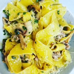 a white bowl filled with pasta and mushrooms