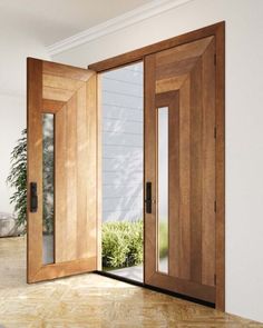 an open wooden door in the middle of a room with windows and doors on both sides