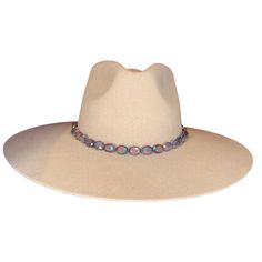 Add sheen to your rodeo look with our hand-crafted deep purple beaded hat band. This hat band features oval beads that adorn the center of the leather band. Crafted from the finest North American deer hides, this hat band is soft, strong, and supple. Due to the self-tie nature of this hat band, it can be adjusted to best fit every cowboy hat in your collection. You can customize this hat band further to your preference by selecting your favorite color of leather band from those offered. This dee Beaded Hat Bands, Purple Hat, Deer Hide, Beaded Hat, Purple Hats, Oval Beads, Handmade Hat, Deer Skin, Hat Band