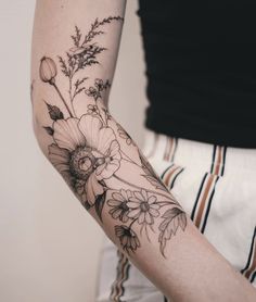 a woman with a flower tattoo on her arm