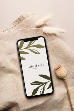 an iphone case with the words little davis printed on it next to a dried plant