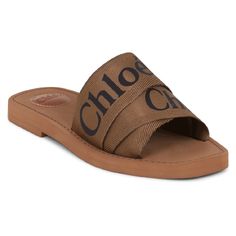 Description The Chloe Woody Logo Slide In Grove Brown Is A Slip-On Style Flat And Features The Iconic Chlo Logo Centrally Printed On The Ribbon Strap. Fabrication: 100% Polypropylene Chic Brown Slides With Leather Footbed, Designer Brown Slides For Spring, Chic Brown Slides With Leather Sole, Chic Brown Round Toe Slides, Chic Brown Slides With Round Toe, Designer Brown Sandals For Spring, Bag And Shoes Closet, Chloe Brand, Chloe Logo