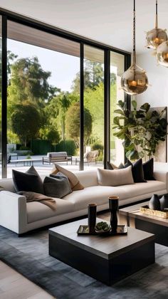 a modern living room with large windows and white couches