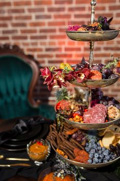 three tiered trays filled with food on top of a table