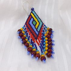 Seed bead earrings, 3 1/8 inch (8cm) drops, beaded fringe earrings, red blue yellow and green glass beads, dramatic jewelry. $45.00, via Etsy. Colorful Bohemian Beaded Earrings With Large Beads, Bohemian Colorful Beaded Earrings With Large Beads, Traditional Beaded Earrings With Tassels, Multicolor Tassel Earrings With Dangling Beads As A Gift, Multicolor Beaded Tassel Earrings As Gift, Red Beaded Earrings With Colorful Beads For Festivals, Traditional Multicolor Beaded Earrings With Tassels, Multicolor Beaded Fringe Earrings As A Gift, Multicolor Beads With Beaded Fringe For Jewelry Making