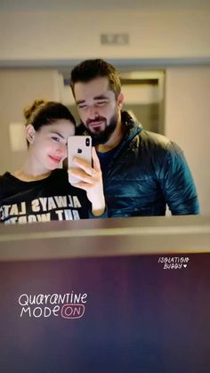 a man and woman taking a selfie in front of a mirror with the caption quarantive mode on