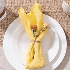 a white plate topped with a yellow napkin