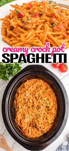 creamy crock pot spaghetti in a black bowl with tomatoes and parsley on the side