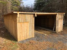 an outhouse in the middle of a wooded area with no one inside or outside