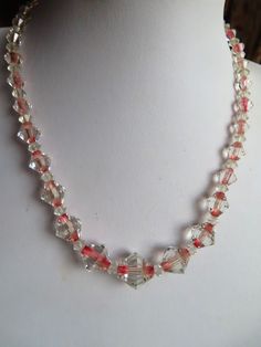 "1950's Unusual Clear with Pink middle Glass Bead Necklace - A lovely Bi-cone shaped necklace clear with a pink middle and has a sterling silver roll over fastener. This necklace is 16.5 inches long.   The main bead is 3/4\" wide and they graduate either side. This necklace is in a good condition." Vintage Pink Faceted Bead Jewelry, Vintage Clear Round Bead Necklaces, Vintage Clear Glass Necklaces, Vintage Clear Glass Necklace, Vintage Clear Necklace For Wedding, Vintage Clear Round Necklace, Vintage Clear Crystal Necklace, Vintage Handmade Clear Necklace, Vintage Handmade Clear Jewelry