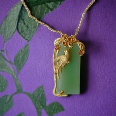 ⭐️ Introducing our Chinese vintage style pendant necklace that the pendant is made in synthetic jade that's in a light green color. Around the jade are flowers and a gold color bird. ⭐️ In Asian culture, the bird Phoenix represents wealth and luck. ⭐️ The necklace is designed in a very vintage color that's unique and adorable to wear. ⭐️ It is a great piece to keep for yourself or to gift to someone special.  ✈️ Handling & Shipping usually takes about 10 days in total, so please consider the processing time if it's a time sensitive gift. 🌹 We are trying our best to package your orders with love and care ❤️ Hope you understand our processing time! ⚠️ Returns & Exchanges: We accept returns and exchanges within 7 days! Handmade Jade Flower Pendant Necklace, Handmade Jade Necklace With Flower Pendant, Green Necklace With Large Flower Pendant, Nature-inspired Jade Pendant Necklace, Green Flower Pendant Necklace With Large Pendant, Nature-inspired Gold Jade Jewelry, Elegant Light Green Necklace For Gift, Vintage Green Rectangular Necklace, Nature-inspired Green Jade Necklaces