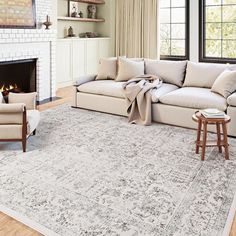 a living room filled with furniture and a fire place in front of a white fireplace