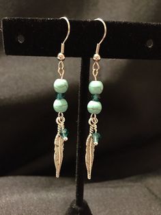 Glass Turquoise Beads with Silver Feather Earrings (Item 515) Turquoise Dangling Beaded Earrings, Elegant Turquoise Beaded Dangling Earrings, Turquoise Metal Dangle Beaded Earrings, Turquoise Metal Beaded Dangle Earrings, Adjustable Turquoise Jewelry With Feathers, Adjustable Blue Feather Earrings, Turquoise Feather Earrings, Feather Earrings Silver, Preppy Jewelry