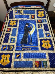 a bed with a harry potter quilt on it