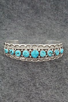 This stunning Kingman turquoise and sterling silver bracelet was made by Navajo silversmith Anthony Brown. The inside of the cuff is signed Anthony B and stamped sterling.Size: 5 1/2" (will fit up to a 6 5/8" wrist)Gap: 1 1/8"Width: 3/4"Free shipping on all orders! We ship with USPS and always include tracking. All orders ship within a day of payment.Returns are accepted up to 30 days after you receive your order. Just send us a message. Our shop offers cash back or store credit. The item must be returned in new condition. Western Style Blue Bangle Jewelry, Southwestern Sterling Silver Cuff Bracelet In Blue, Southwestern Turquoise Bangle, Southwestern Style Turquoise Bracelet Stamped 925, Southwestern Style Stamped Turquoise Bracelets, Southwestern Style Stamped Blue Bracelets, Southwestern Style Turquoise Stamped Bracelets, Southwestern Blue Concho Bracelets, Southwestern Engraved Blue Cuff Bracelet