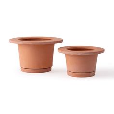 two clay pots sitting next to each other