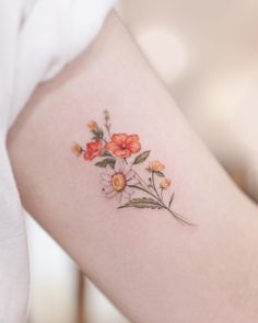 a close up of a person's arm with flowers on it