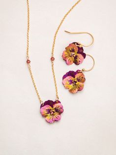 A fantastic display of an iconic springtime bloom, our Garden Pansy Drop Earrings are a must-have for the Holly Yashi collector, or anyone who wants to freshen up their look! Striking for their small size, these cheerful varietals feature life-like overlapping ruffled petals in a brilliant range of candy store hues. Ear wires are 925 sterling silver with a 18k gold overlay and hypoallergenic. Style Number: 15289 Metal: 18k Gold Vermeil Ear Wires and Niobium Gemstone: Austrian Crystal Dimensions: Pansy Jewelry, Pansy Necklace, Burgundy Garden, Holly Yashi, Nice Accessories, Pretty Jewelry Necklaces, Steampunk Accessories, Floral Bracelet, Book Jewelry