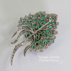 Stunning burst of vivid green emeralds and sparkly white diamonds covering all the surfaces of this beautiful platinum vintage brooch! Total Weight: 29.15 grams Size: 2.5 inch tall, 1.5 inch wide Precious Metal: Platinum Precious stones: -Emeralds: QTY: 31, 2.7mmx4.7mm to 4.2mmx6.3mm size, 7.5 carats -Diamonds: 29 rounds, 20 baguettes, 6 carats Green Diamond Wedding Brooches, Fine Jewelry Green Gemstone Brooches, Vintage Green Diamond Brooches, Luxury Green Brooches For Wedding, Fine Jewelry Green Brooch For Anniversary, Elegant Green Diamond Brooch, Fine Jewelry Green Brooches For Anniversary, Green Fine Jewelry Brooch For Anniversary, Luxury Green Brooch For Anniversary