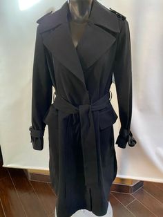 Maximize your look in the maxi silhouette of this long trench coat from London Fog, a water-resistant pick designed with a waist-defining belt. Approx. 45" long   front button closures removable belt Water-resistant; belted Two flap pockets at hip Lined Shell, lining:polyester Machine washable Imported BUST:  44" WAIST:  41" Sleeve length: 26" shoulder to shoulder:   18" across Please Check out my other items! Shipping: Combine shipping is available, please message us when you done your shopping Long Trench, Long Trench Coat, Trench Jacket, London Fog, Black Midi, Jacket Coat, Vest Jacket, Trench Coat, Coats Jackets