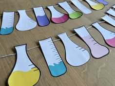 paper cutouts with measurings and colors hanging on a line