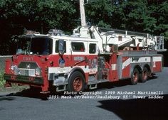 a red and white fire truck parked on the street