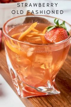 an old fashioned drink is garnished with strawberries