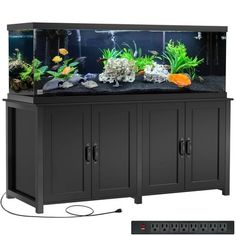 an aquarium with many different types of plants and rocks in the bottom section, along with a remote control