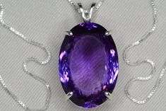 "This amethyst necklace features a genuine earth mined amethyst with a fabulous purple color. The necklace and pendant are made of solid sterling silver. This item is brand new and has been certified by the Canadian Federal Gemological Laboratory of Canada. The certificate will be included and describes the amethyst as follows:  \"Shape and cut: Oval Weight: 53.43 ct Species: Natural Quartz Variety: Amethyst Colour: Purple Transparency: Transparent Luster: Vitreous Refractive Index: 1.55 - 1.56 Identifying characteristics: Internal M.S.R.P: $3,740.00 CAD\" Please feel free to browse my shop for hundreds of additional pieces of certified gemstone jewelry including an excellent selection of fine quality amethyst pieces: https://www.etsy.com/shop/SilverJewelery Also please take a moment to re Formal Purple Gemstone Necklace, Classic Amethyst Purple Necklace, Classic Purple Amethyst Necklace, Luxury Purple Necklaces For Anniversary, Luxury Purple Necklace For Anniversary, Formal Purple Amethyst Necklace, Formal Purple Tanzanite Jewelry, Formal Amethyst Jewelry With Large Stone, Formal Large Stone Amethyst Jewelry