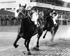 two jockeys on horses racing down the track in black and white photo canvas wall art print