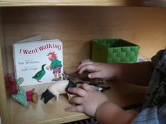 a child is playing with toys on a shelf