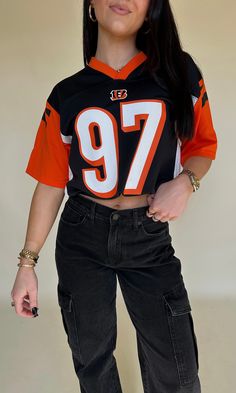 FINAL SALE Cincinnati Bengals football jersey - number 97. Black base, white breathable sides & orange sleeves. "Atkins" on the back. Never been worn. ﻿Size YOUTH large - fits similar to an adult medium. Orange Black White Outfit, Throwback Tops For Team Events During Sports Season, Black College Football Season Jersey, Casual Black Jersey For Game Day, Black Number Print Top For Game Day, Black Sports Tops With Number Print For Events, Black Tops For Game Day During Football Season, Sporty College Jersey For Football Season, Sporty College Football Season Jersey