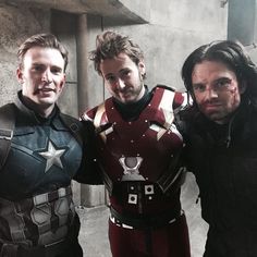 three men dressed as captain america posing for a photo