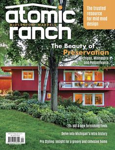 the front cover of a magazine with an image of a red house and trees on it