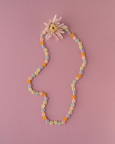 Delicate and playful, our handmade flower beaded necklace adds a touch of charm to any outfit. Crafted with love, it's designed to brighten your day and keep the spirit of summer alive year-round. Summer Beaded Necklaces With Flower Charm As Gift, Summer Gift Beaded Necklace With Flower Charm, Summer Flower Beaded Necklaces, Multicolor Round Beads Flower Necklace For Summer, Spring Multicolor Beaded Flower Necklace, Multicolor Beaded Necklace With Flower Charm For Summer, Summer Flower Necklace With Tiny Beads, Summer Flower Pendant Necklace Gift, Summer Flower Necklace With Tiny Round Beads