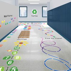 the floor is decorated with colorful numbers and symbols in an office building hallway that has blue lockers on both sides