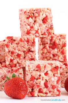 strawberry rice krispy treats stacked on top of each other with strawberries next to them