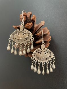 One Pair Hmong Silver Earrings,Vintage Earrings,Floral Design,Miao Silver ,Tribal Jewelry ,Boho Style. This earrings is handmade craft by our family lived in minority area Southwest of China. It's very unique. Also can bring you much luck. It's special workmanship. It can be a special gift. Width: 3cm Height:2cm Weight: 10g Care Instruction:  ❥. Avoid wearing the same miao silver jewelry for a long time.Take off your jewelry before bathing or swimming. ❥. Miao silver jewelry should avoid rubbing Bohemian Earrings With Intricate Design For Festivals, Bohemian Chandbali Earrings, Vintage Earrings With Intricate Design, Bohemian Drop Danglers, Bohemian Chandelier Earrings With Intricate Design For Gift, Bohemian Antique Silver Pierced Jewelry, Handmade Silver Danglers For Festival, Vintage Pierced Jewelry For Festivals, Handmade Metal Earrings For Vintage Collection