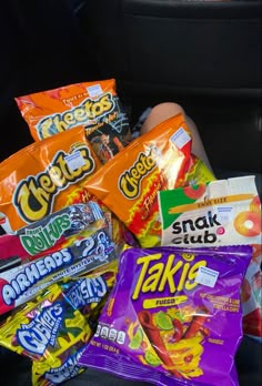 a pile of snacks sitting in the back seat of a car